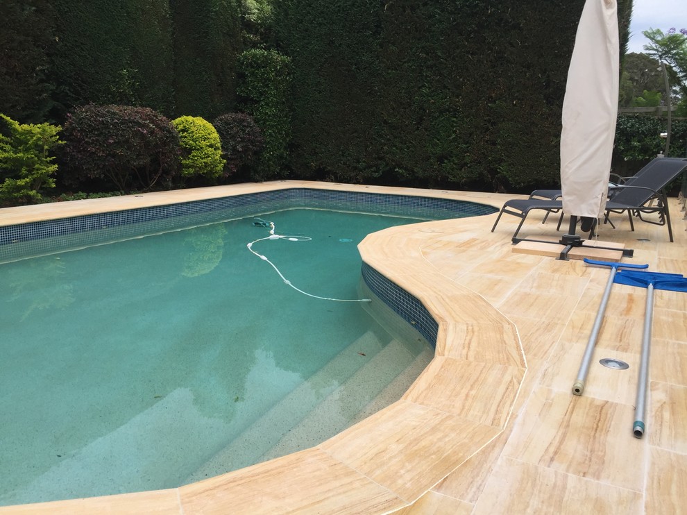 Mid-sized mediterranean backyard custom-shaped lap pool in Sydney.