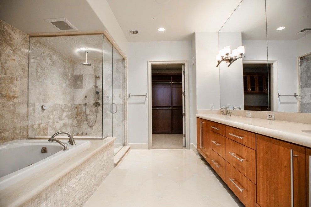 Design ideas for a large modern master bathroom in Las Vegas with a drop-in sink, flat-panel cabinets, medium wood cabinets, marble benchtops, a drop-in tub, a corner shower, a one-piece toilet, white tile, stone tile, white walls and marble floors.