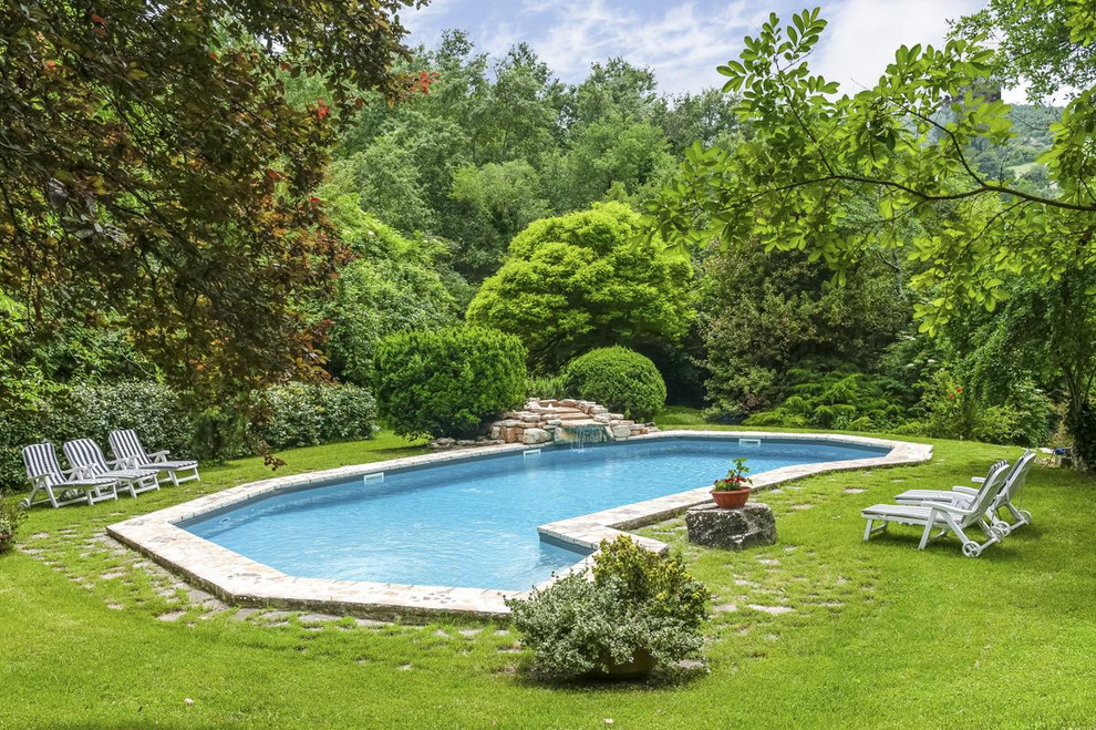 This is an example of a mediterranean backyard custom-shaped pool in Other.