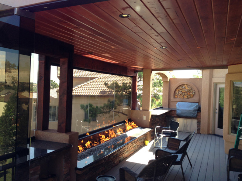 Deck - backyard deck idea in Denver with a fire pit and a roof extension