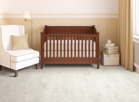 Design ideas for a mid-sized contemporary gender-neutral nursery in Other with beige walls and cork floors.