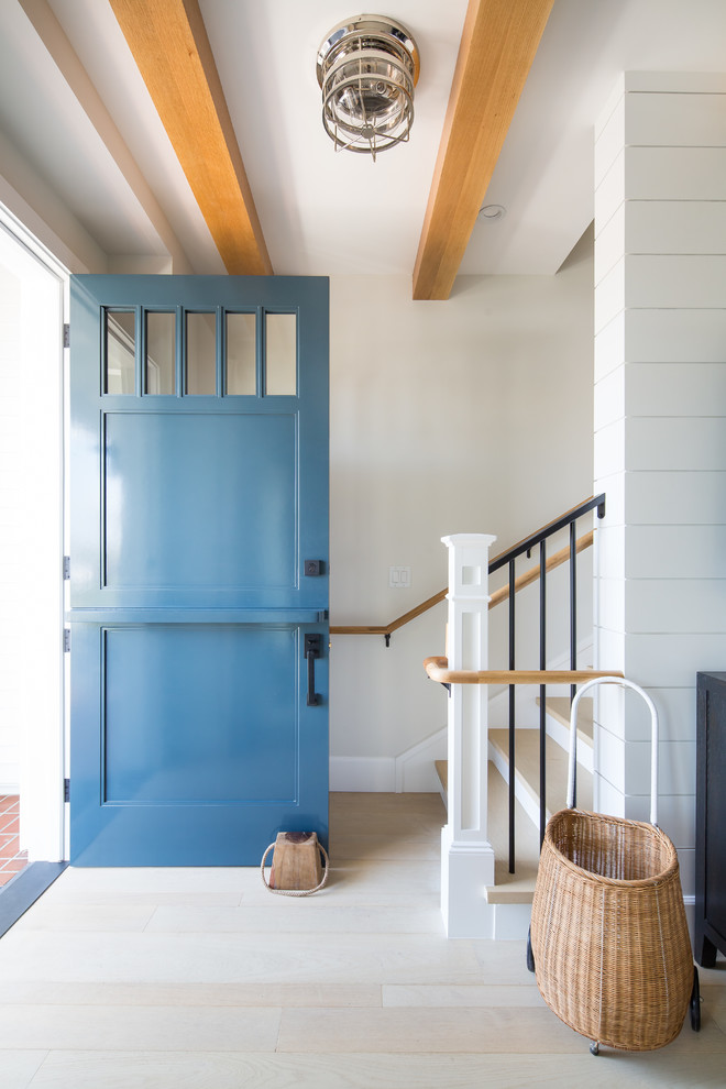 Inspiration for a beach style foyer in Orange County with white walls, light hardwood floors, a dutch front door, a blue front door and beige floor.