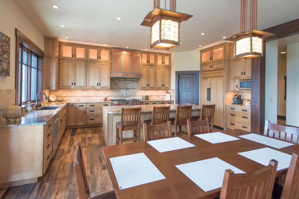 Large country l-shaped open plan kitchen in Boise with an undermount sink, recessed-panel cabinets, light wood cabinets, granite benchtops, beige splashback, terra-cotta splashback, panelled appliances, dark hardwood floors, with island, blue floor and grey benchtop.