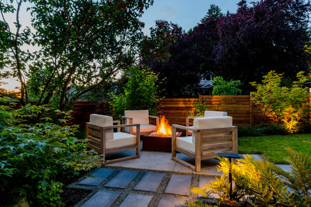 Small contemporary backyard partial sun garden in Seattle with a fire feature and concrete pavers.