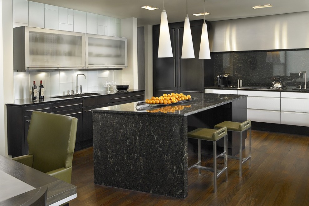 Contemporary l-shaped eat-in kitchen in Chicago with glass-front cabinets, black splashback, stone slab splashback, black appliances and black benchtop.