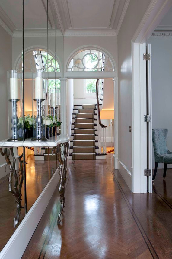 Photo of a small contemporary hallway in London with white walls and dark hardwood floors.
