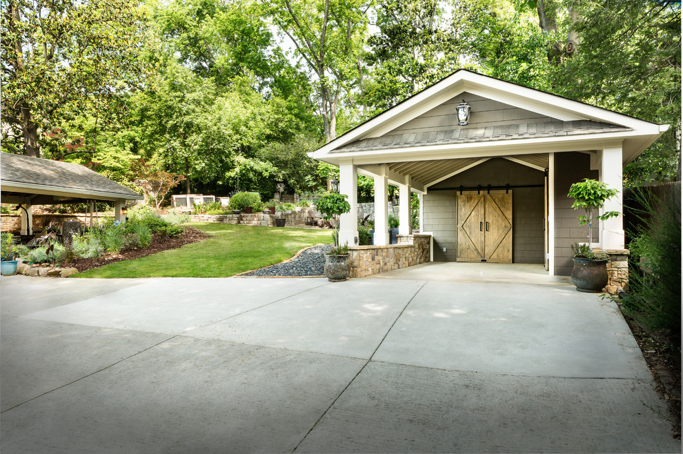 Photo of a mid-sized traditional detached three-car garage in Atlanta.