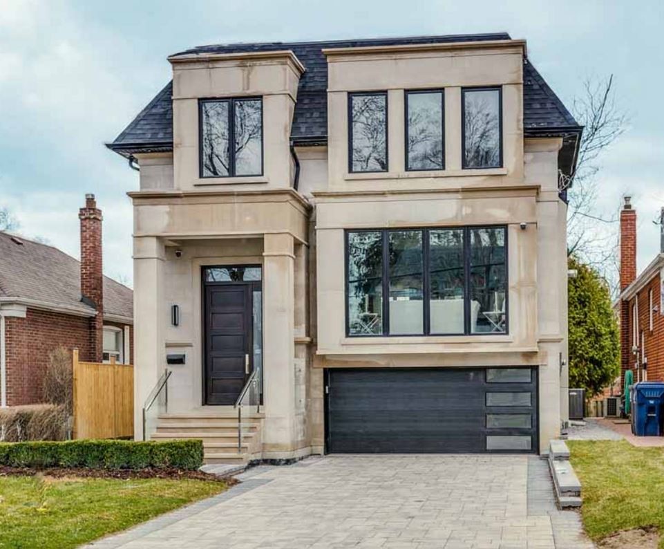Design ideas for a small modern two-storey brick beige exterior in Toronto with a clipped gable roof.
