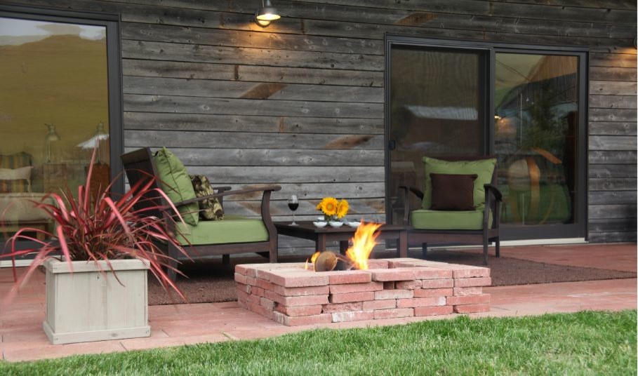 Design ideas for a large eclectic backyard patio in Los Angeles with a fire feature, concrete pavers and a roof extension.