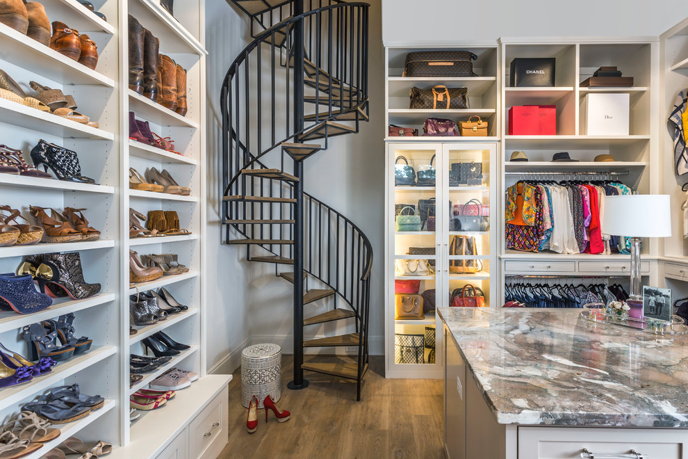 Inspiration for a transitional women's walk-in wardrobe in Houston with open cabinets, white cabinets, dark hardwood floors and brown floor.