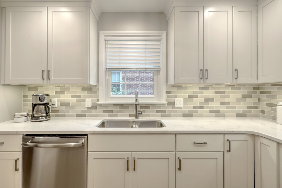 Inspiration for a small transitional ceramic tile and beige floor kitchen remodel with a double-bowl sink, shaker cabinets, quartz countertops, beige backsplash, ceramic backsplash, stainless steel appliances and white countertops