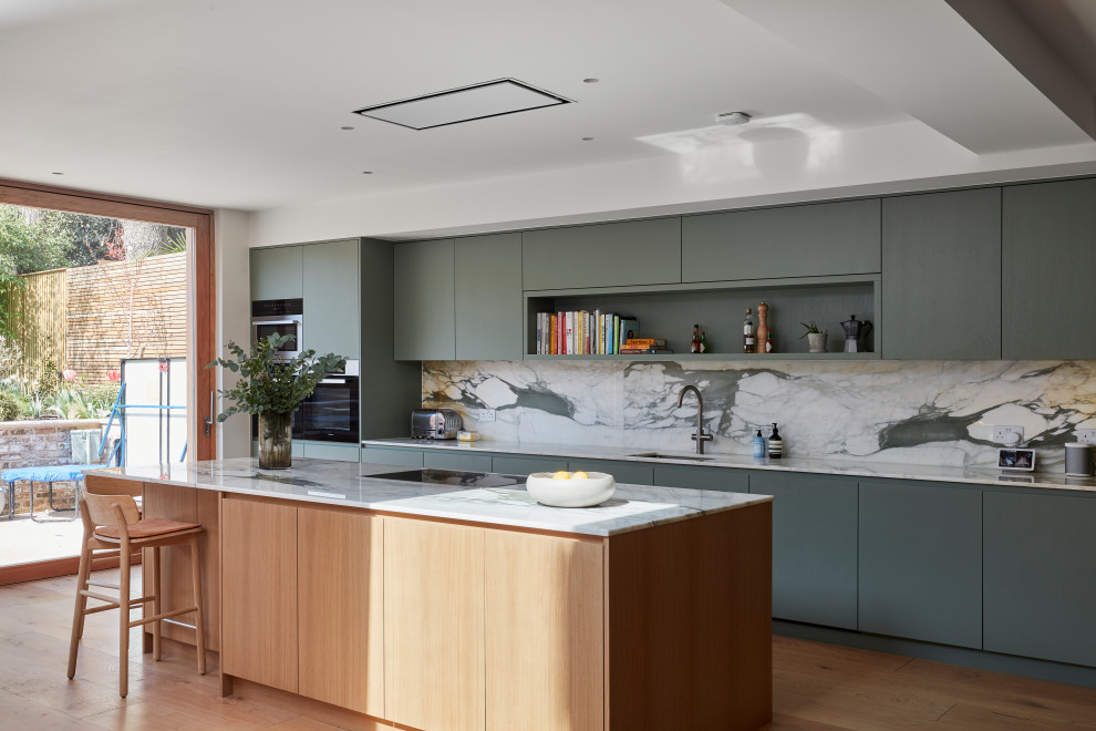 Photo of a contemporary grey and white single-wall open plan kitchen in London with marble worktops, multi-coloured splashback, marble splashback, an island and multicoloured worktops.