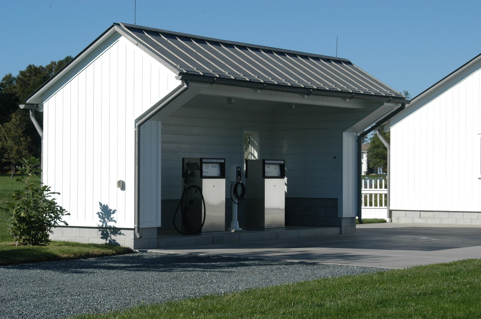 Photo of a mid-sized country one-storey white exterior in DC Metro with stone veneer and a shed roof.