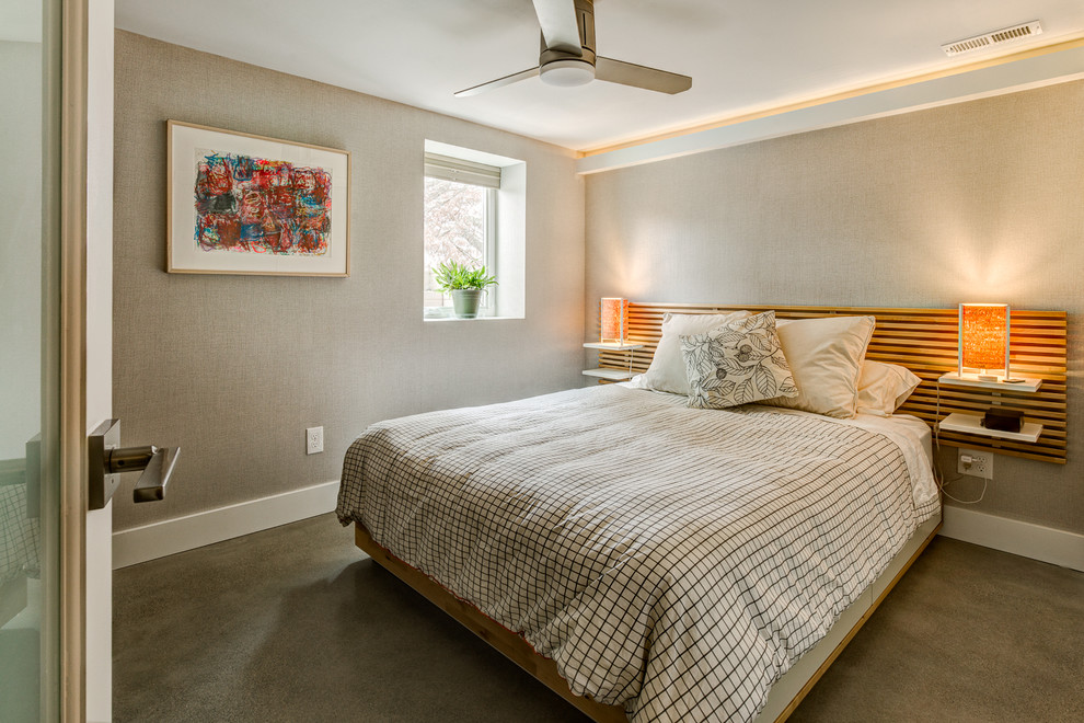 This is an example of a mid-sized contemporary guest bedroom in Los Angeles with white walls, concrete floors and no fireplace.