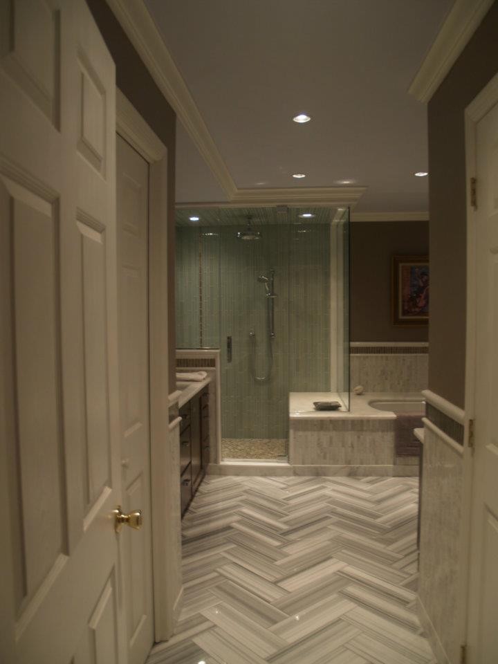 Design ideas for a large transitional master bathroom in New York with shaker cabinets, dark wood cabinets, an undermount tub, an alcove shower, brown tile, glass tile, brown walls, an integrated sink and quartzite benchtops.