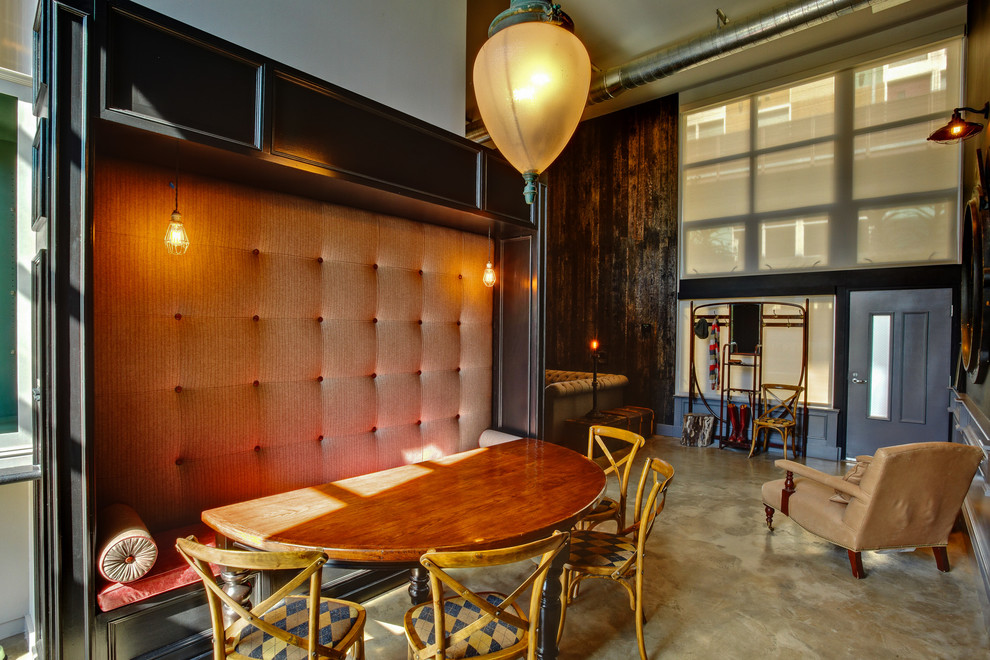 Photo of an industrial dining room in Los Angeles with concrete floors.