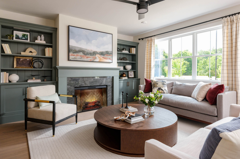 Inspiration for a transitional medium tone wood floor and brown floor living room remodel in Boston with beige walls, a standard fireplace and a stone fireplace
