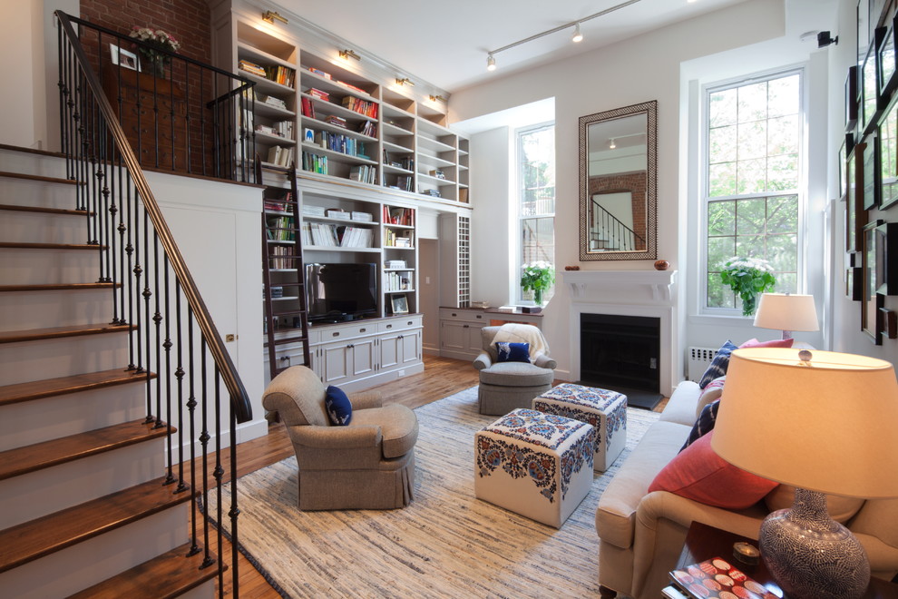 Photo of a transitional living room in New York with a library.