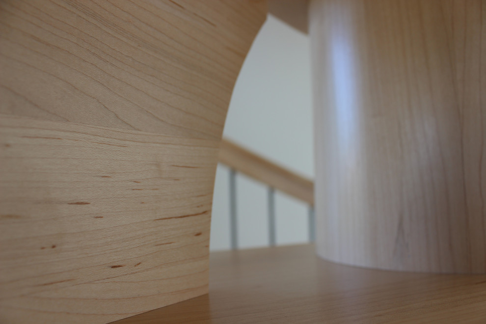 Inspiration for a small transitional wooden spiral mixed material railing staircase remodel with wooden risers