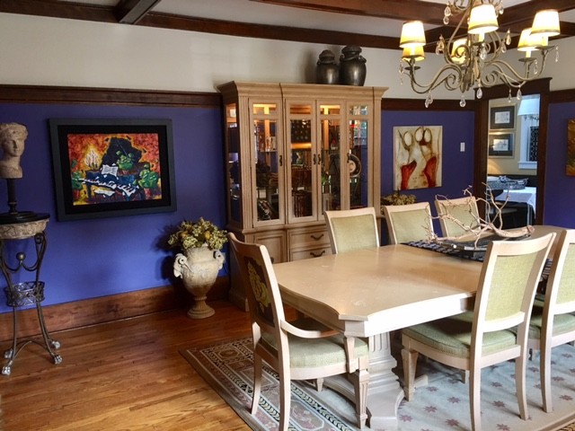 Inspiration for a transitional brown floor dining room remodel in Ottawa with purple walls