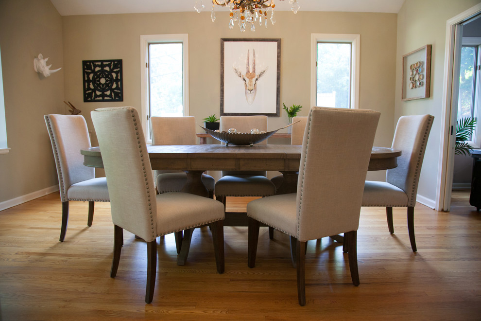 This is an example of a mid-sized transitional separate dining room in New York with beige walls and light hardwood floors.