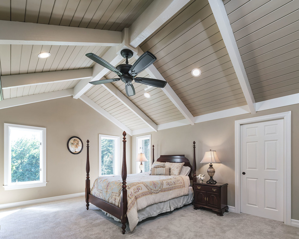 Photo of a mid-sized traditional master bedroom in Other with beige walls, carpet and beige floor.