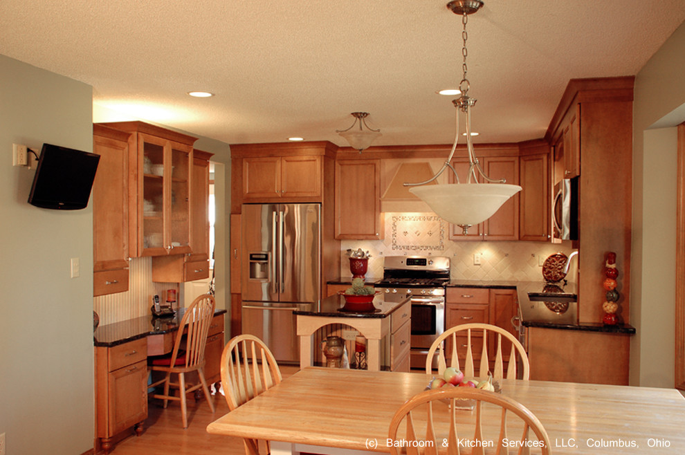 Mid-sized transitional medium tone wood floor eat-in kitchen photo in Columbus with an undermount sink, granite countertops, beige backsplash, stone tile backsplash, stainless steel appliances, green walls, an island, flat-panel cabinets and medium tone wood cabinets