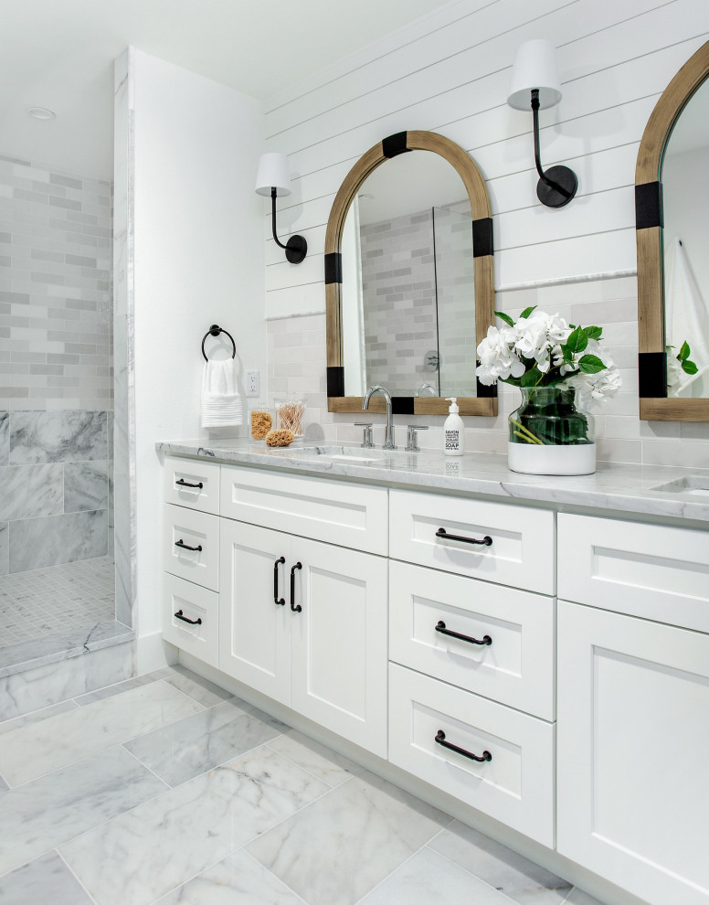 Medium sized beach style ensuite bathroom in Dallas with shaker cabinets, white cabinets, an alcove shower, white tiles, marble tiles, white walls, marble flooring, a submerged sink, marble worktops, yellow floors, a hinged door, white worktops, double sinks and a built in vanity unit.