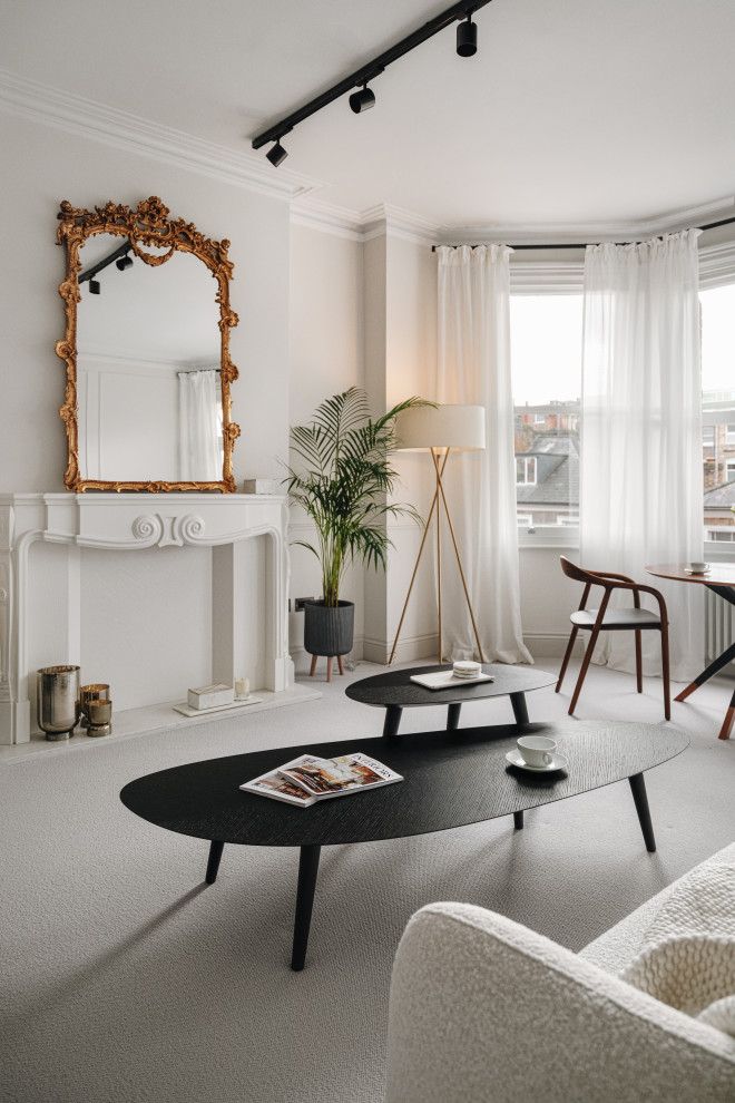 Medium sized eclectic formal and grey and black enclosed living room in London with white walls, carpet, a timber clad chimney breast, no tv, grey floors, wainscoting and a chimney breast.