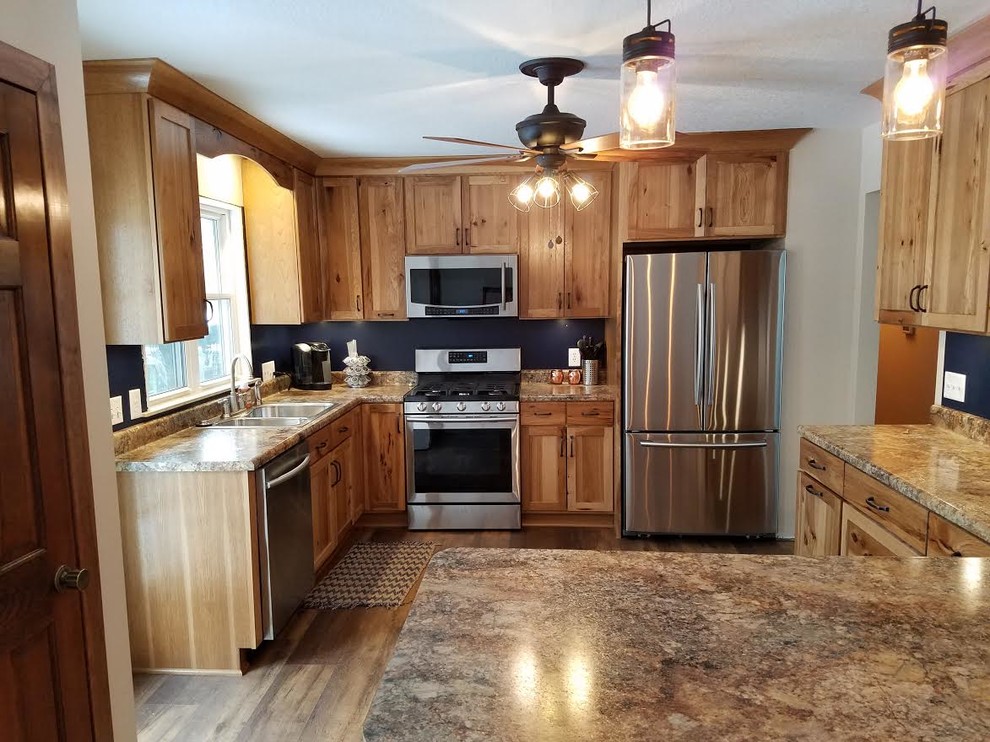 Mid-sized country u-shaped separate kitchen in Chicago with a double-bowl sink, shaker cabinets, medium wood cabinets, granite benchtops, blue splashback, stainless steel appliances, medium hardwood floors, with island, brown floor and beige benchtop.