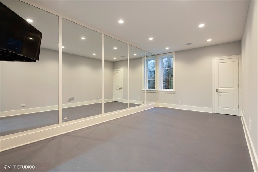 This is an example of a large transitional multipurpose gym in Chicago with grey walls and grey floor.