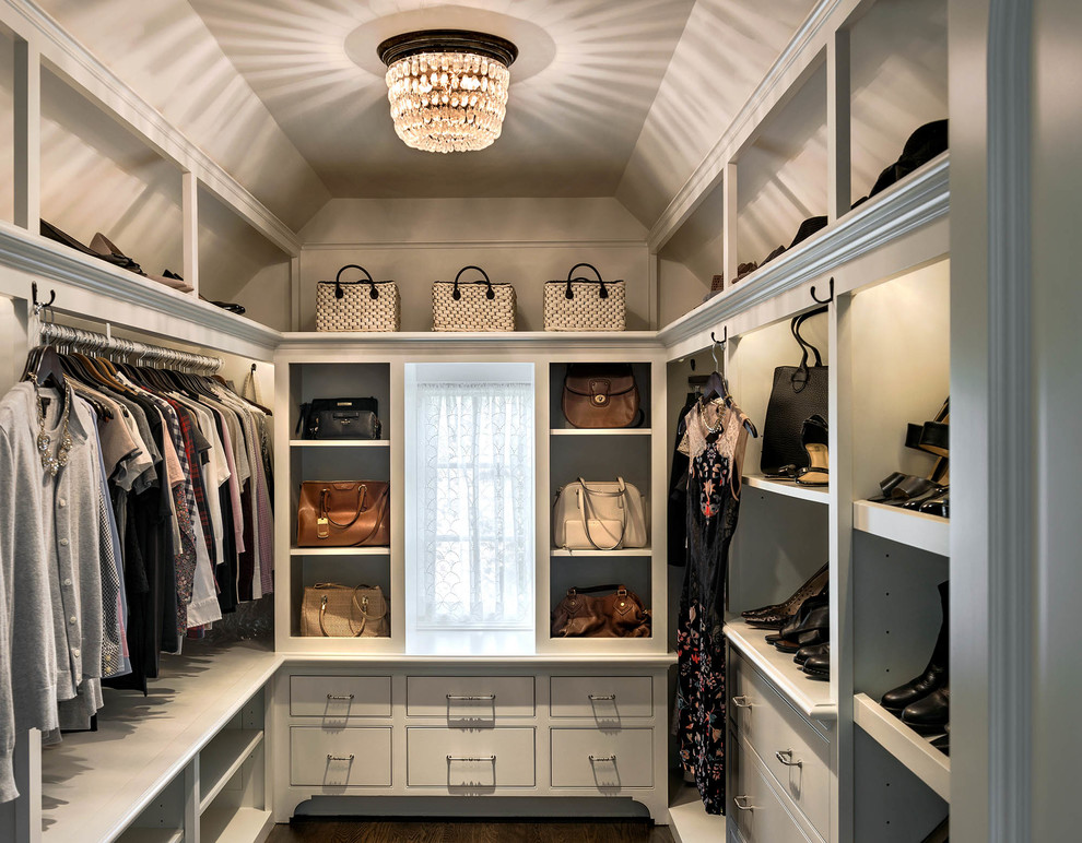 Traditional walk-in wardrobe in Boston with flat-panel cabinets, white cabinets, dark hardwood floors and brown floor.