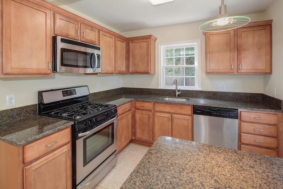 Photo of a traditional l-shaped kitchen in DC Metro with a single-bowl sink, medium wood cabinets, granite benchtops, stainless steel appliances, ceramic floors and with island.