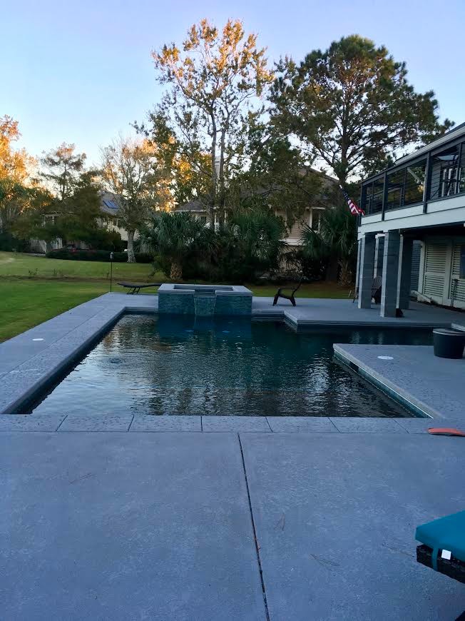 Small transitional backyard concrete paver and l-shaped lap hot tub photo