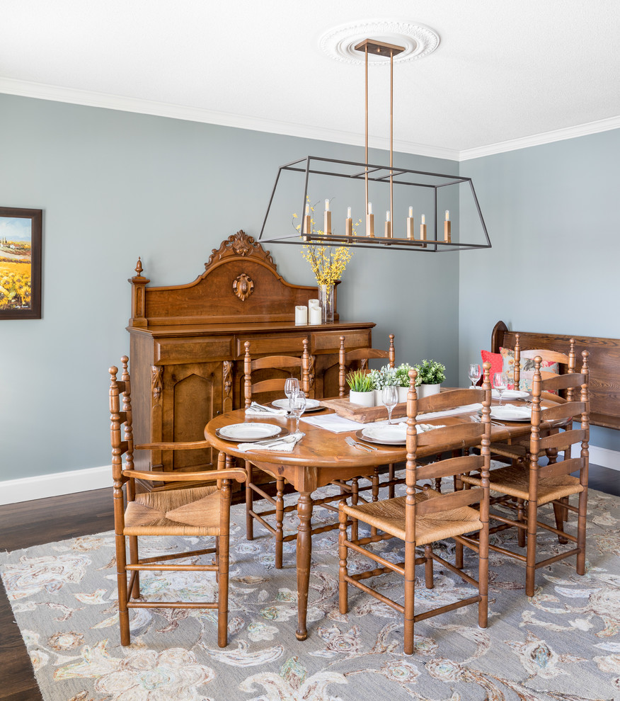 Traditional separate dining room in Toronto with blue walls, dark hardwood floors and brown floor.