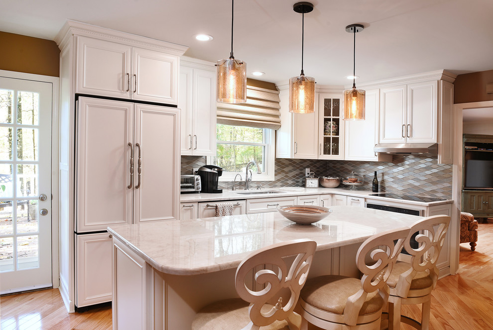 Design ideas for a transitional separate kitchen in Baltimore with recessed-panel cabinets, white cabinets, beige splashback, panelled appliances, light hardwood floors and with island.