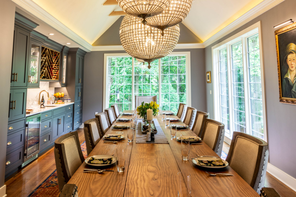 Enclosed dining room - large transitional medium tone wood floor, brown floor and exposed beam enclosed dining room idea with gray walls