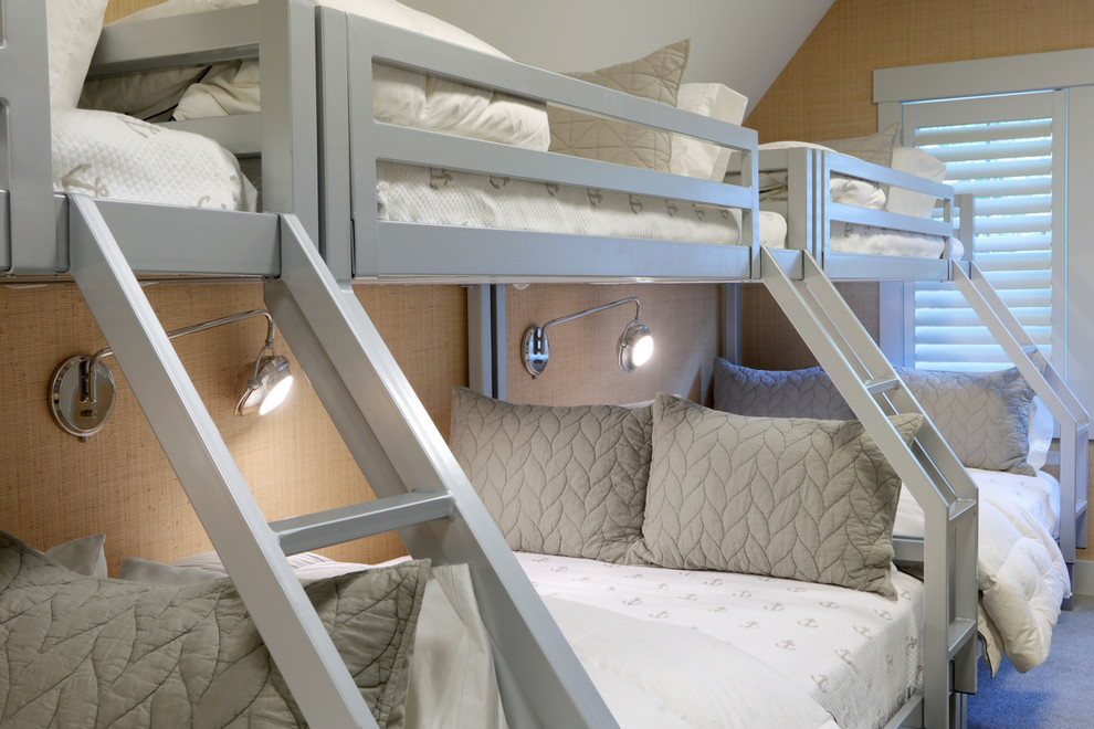 Fairfield - Modern Farmhouse - Bunk Bed Detail - Builder: Falcon Custom Homes
Interior Designer: Mary Burns - Gallery
Photographer: Mike Buck

A perfectly proportioned story and a half cottage, the Farfield is full of traditional details and charm. The front is composed of matching board and batten gables flanking a covered porch featuring square columns with pegged capitols. A tour of the rear façade reveals an asymmetrical elevation with a tall living room gable anchoring the right and a low retractable-screened porch to the left. 

Inside, the front foyer opens up to a wide staircase clad in horizontal boards for a more modern feel. To the left, and through a short hall, is a study with private access to the main levels public bathroom. Further back a corridor, framed on one side by the living rooms stone fireplace, connects the master suite to the rest of the house.  Entrance to the living room can be gained through a pair of openings flanking the stone fireplace, or via the open concept kitchen/dining room. Neutral grey cabinets featuring a modern take on a recessed panel look, line the perimeter of the kitchen, framing the elongated kitchen island. Twelve leather wrapped chairs provide enough seating for a large family, or gathering of friends. Anchoring the rear of the main level is the screened in porch framed by square columns that match the style of those found at the front porch. Upstairs, there are a total of four separate sleeping chambers. The two bedrooms above the master suite share a bathroom, while the third bedroom to the rear features its own en suite. The fourth is a large bunkroom above the homes two-stall garage large enough to host an abundance of guests.