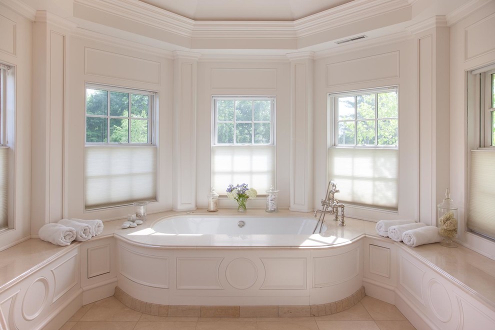 Traditional master bathroom in New York with white cabinets, white walls and porcelain floors.