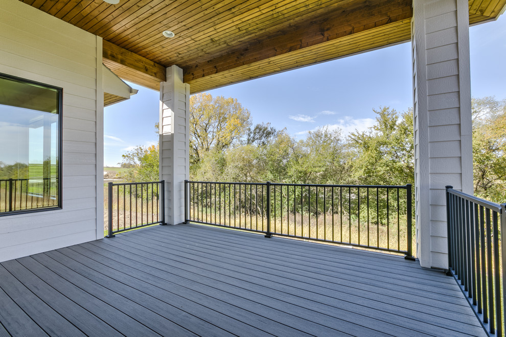 Photo of a contemporary backyard patio in Omaha with decking and a roof extension.