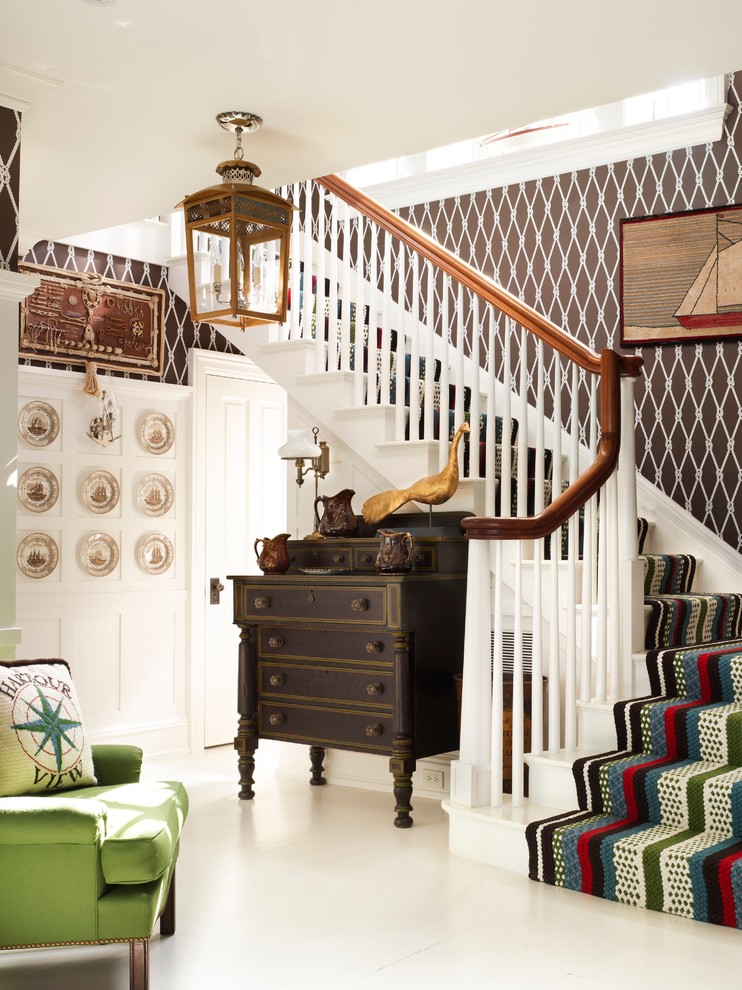 Beach style painted wood l-shaped staircase in New York with painted wood risers.