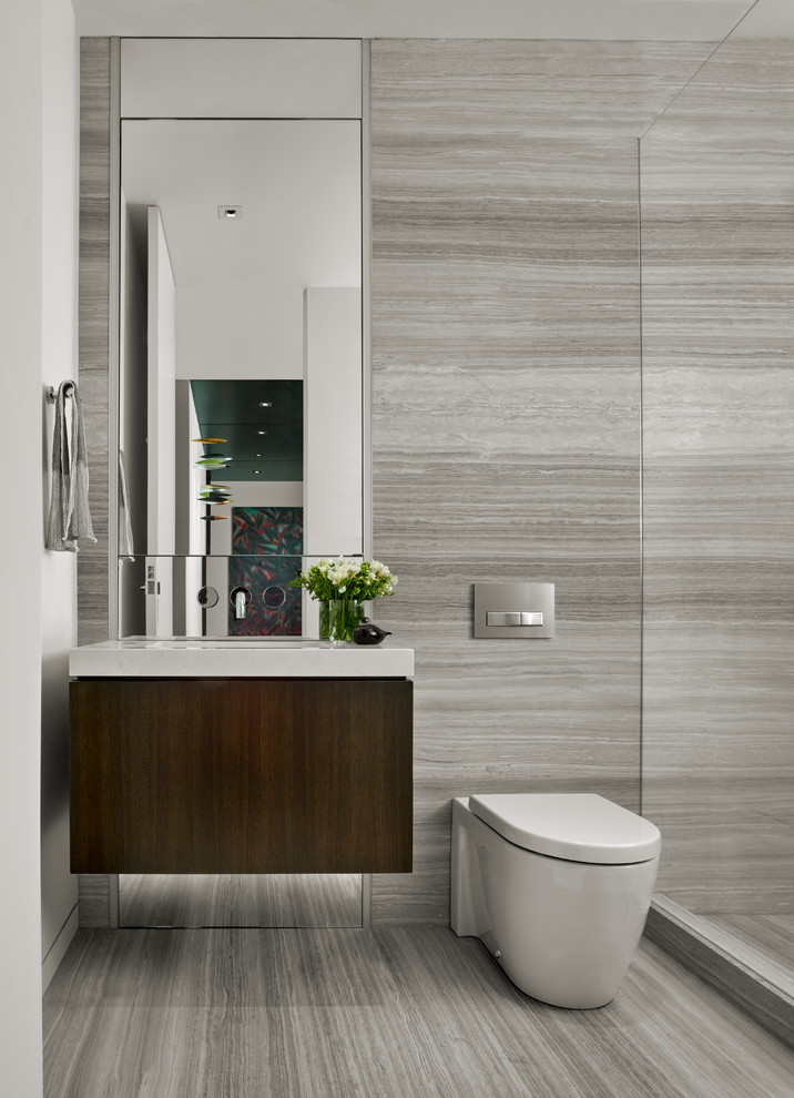 Inspiration for a mid-sized contemporary bathroom in San Francisco with dark wood cabinets, an open shower, a one-piece toilet, beige tile, stone slab, beige walls, travertine floors, an undermount sink and solid surface benchtops.