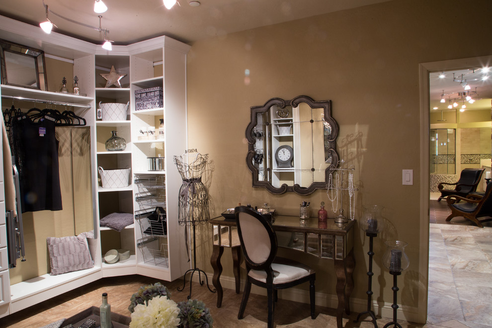 Design ideas for an expansive traditional women's dressing room in Phoenix with open cabinets, white cabinets and travertine floors.