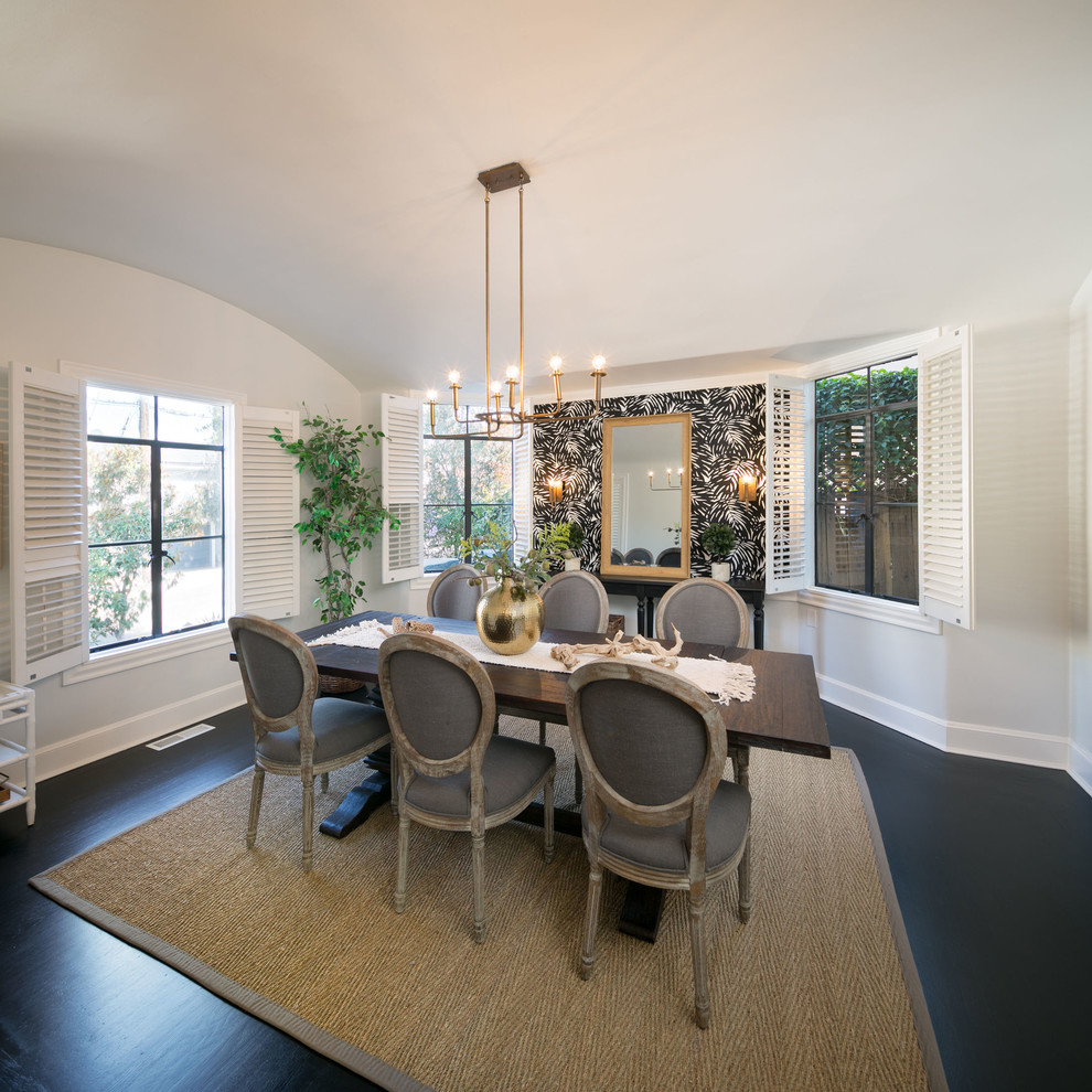 This is an example of a mid-sized traditional separate dining room in San Francisco with white walls, dark hardwood floors and black floor.