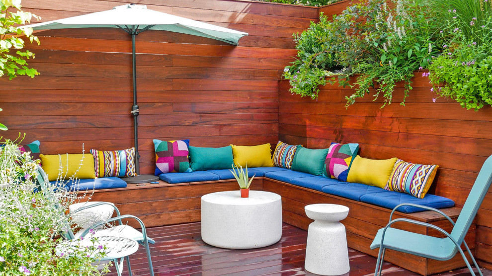 Photo of a small contemporary backyard deck in New York with a container garden.