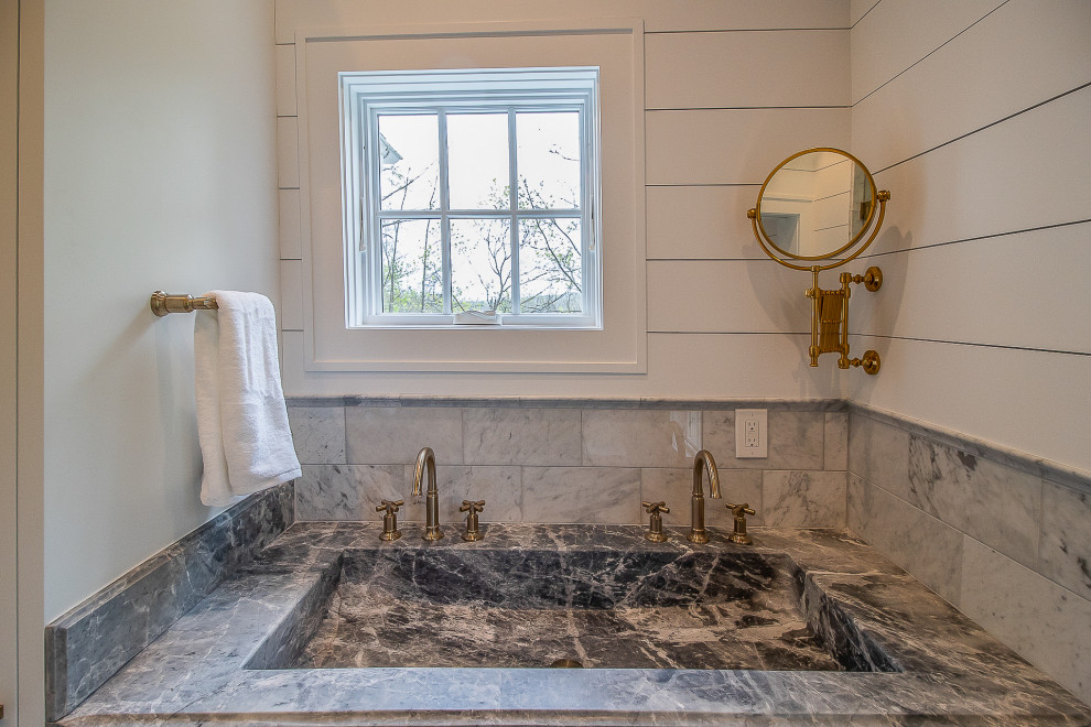 This is an example of a large traditional master bathroom in Cleveland with recessed-panel cabinets, dark wood cabinets, a corner tub, a corner shower, a one-piece toilet, gray tile, ceramic tile, multi-coloured walls, ceramic floors, marble benchtops, multi-coloured floor, a hinged shower door, multi-coloured benchtops, a shower seat, a single vanity, a built-in vanity, wood and planked wall panelling.