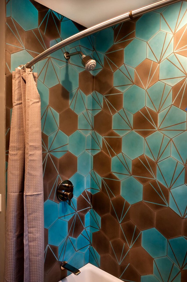 Inspiration for a mid-sized contemporary 3/4 bathroom in San Diego with furniture-like cabinets, green cabinets, an alcove tub, a shower/bathtub combo, a one-piece toilet, multi-coloured tile, cement tile, beige walls, cement tiles, a vessel sink, wood benchtops, multi-coloured floor and a shower curtain.