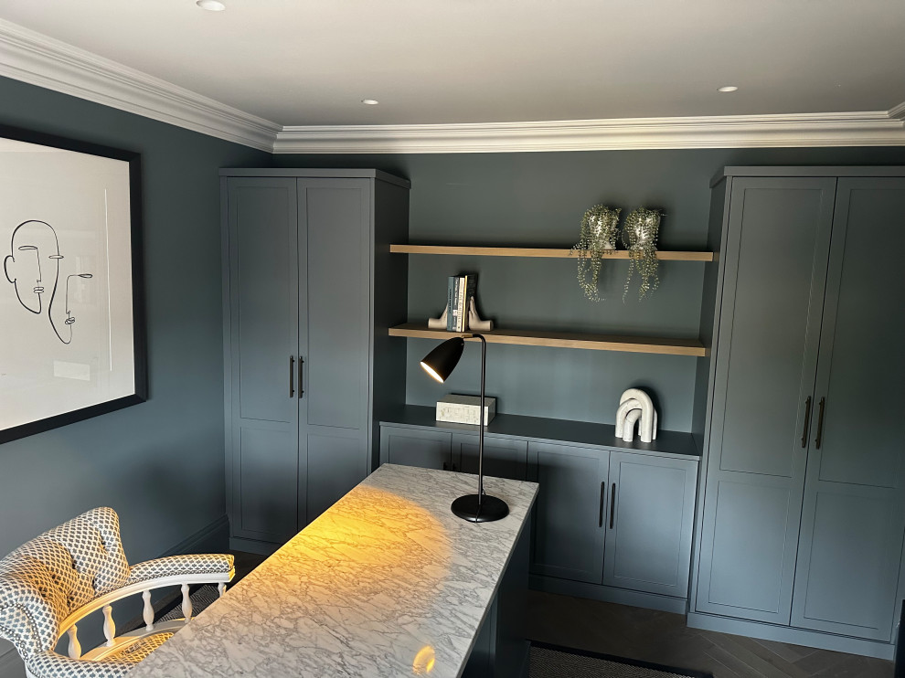 This is an example of a contemporary home office in Hertfordshire with grey walls and a freestanding desk.