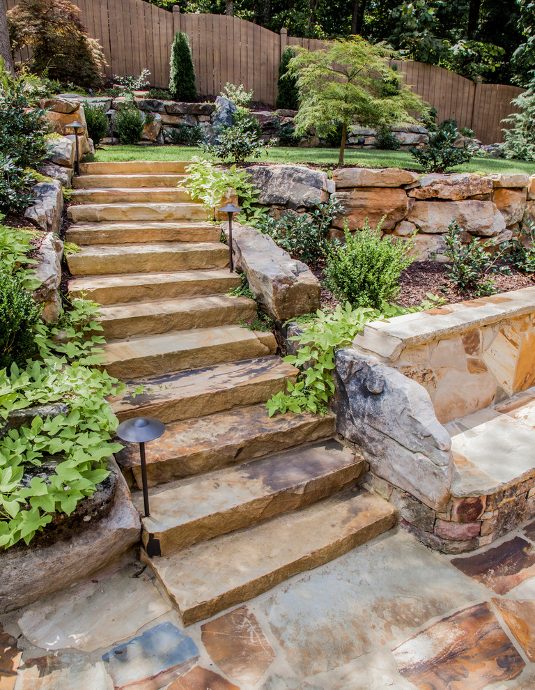 Photo of a large contemporary backyard garden in Atlanta with natural stone pavers.