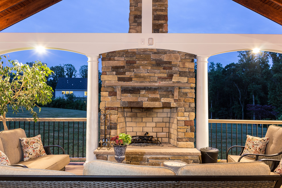 Inspiration for a backyard deck remodel in Baltimore with a roof extension